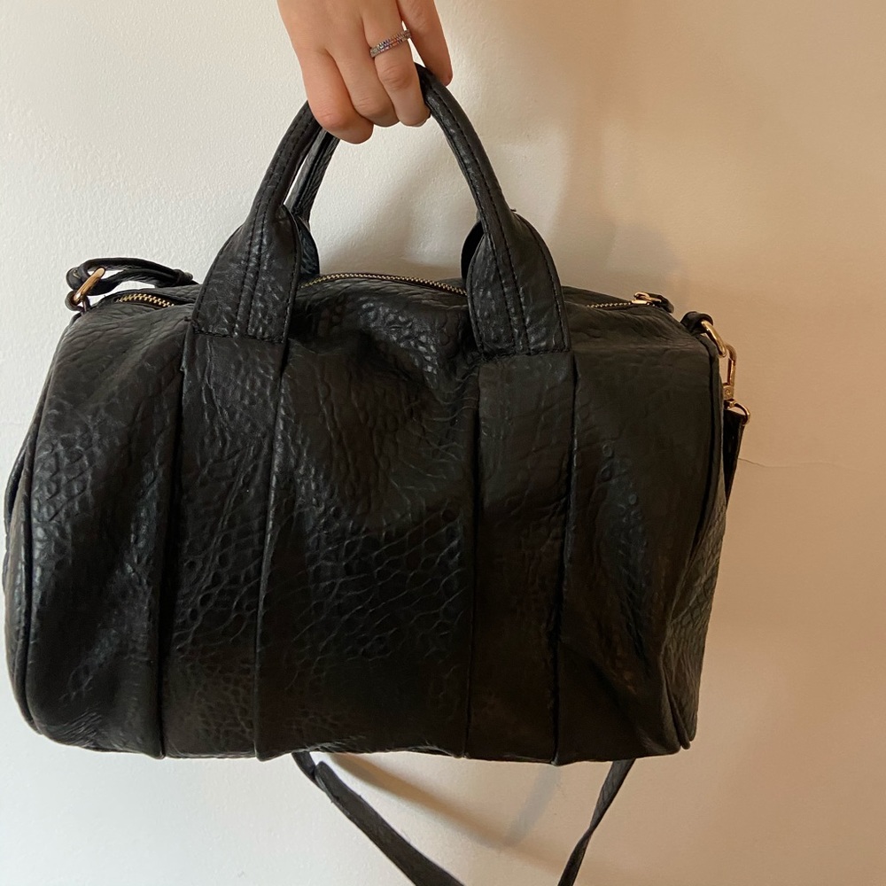 Black faux leather bag with gold studded bottom